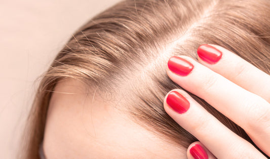 Woman looks at hair loss